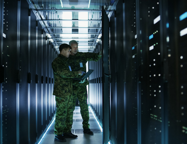 Two military men in a server room